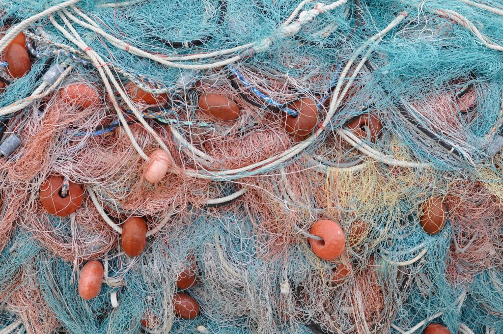 A big pile of fishing nets and buoys. 